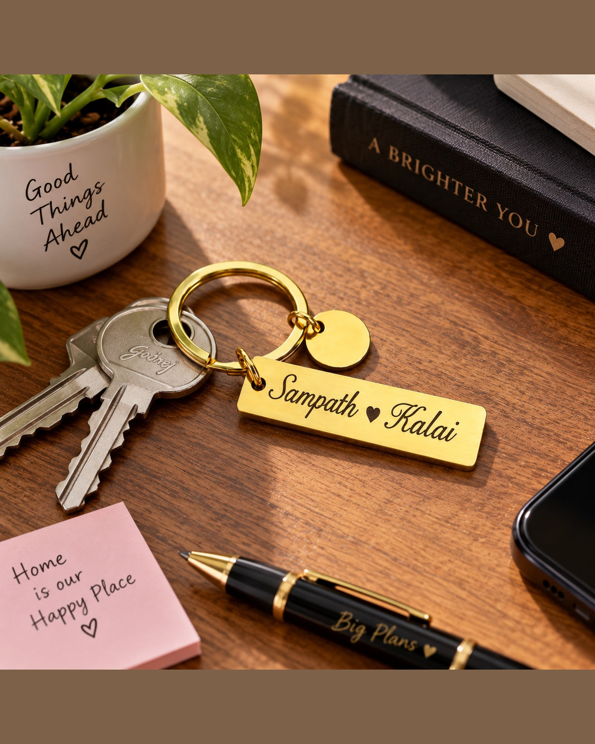 Custom couple keychain with laser engraved names and heart on a desk with house keys